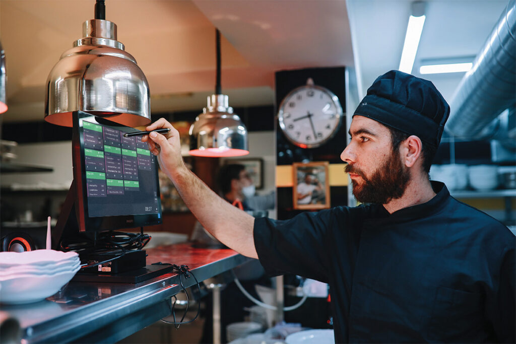 TouchKitchen A chef utilising an ICRTouch TouchKitchen digital kitchen display system